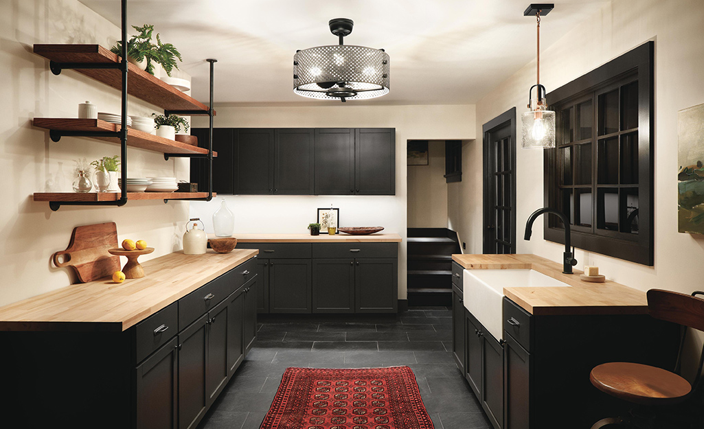 A kitchen with open wood shelves installed on a tiled wall.