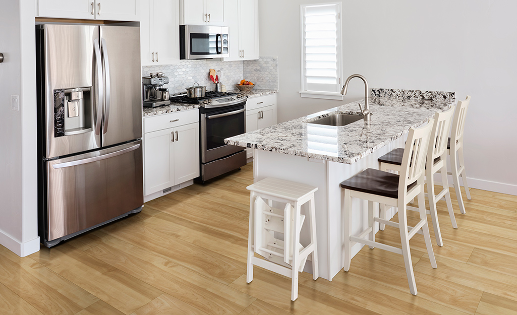 Wood floors installed in a small kitchen.