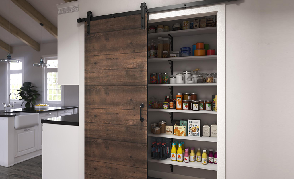 A barn door covering a kitchen pantry.