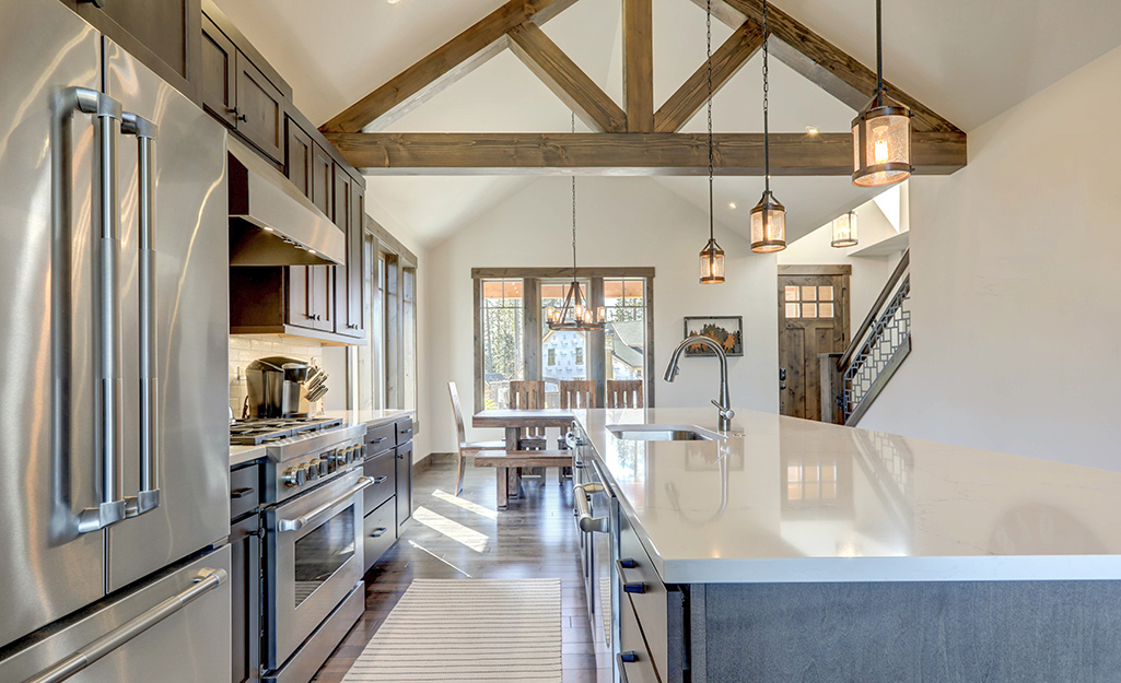 A triangular wood beam installed in a modern kitchen.