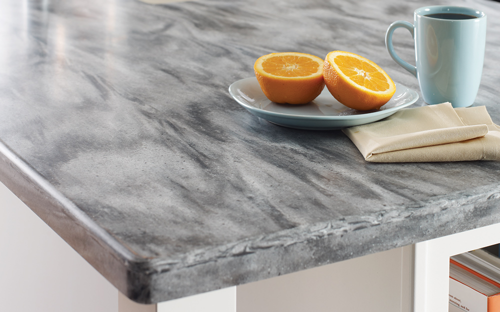 Coffee and a sliced orange on a kitchen countertop.