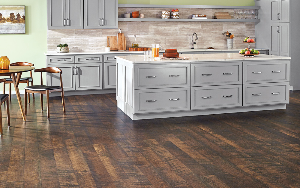 A kitchen with wood-look laminate flooring.