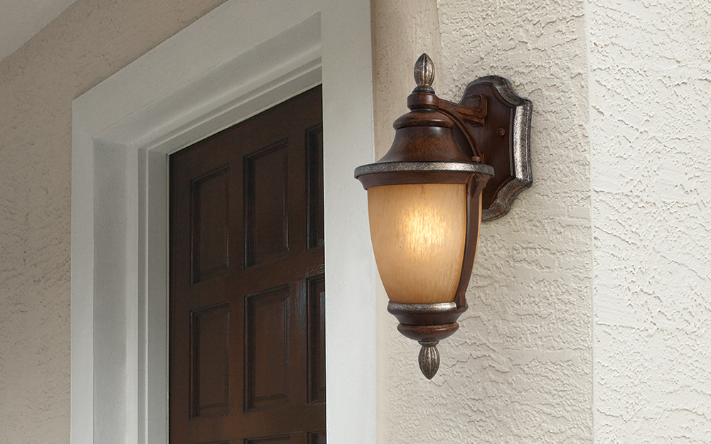 a wall sconce on the exterior of a house