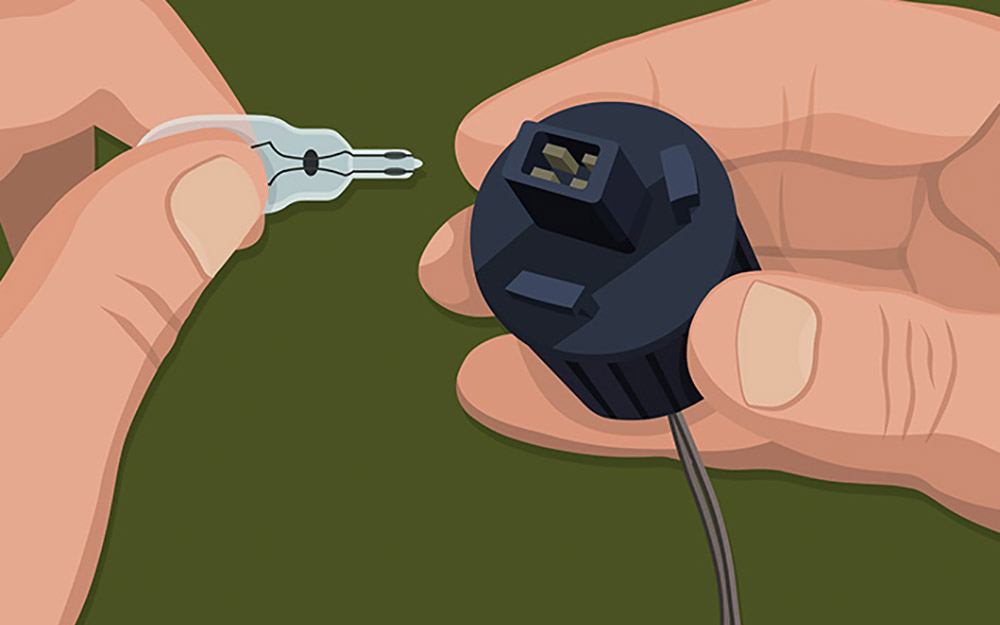 A person assembling landscape lights. A person assembling landscape lights.