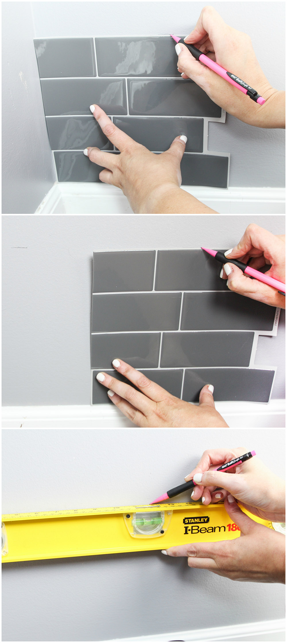 A person drawing lines on Smart Tiles and leveling them on a wall.
