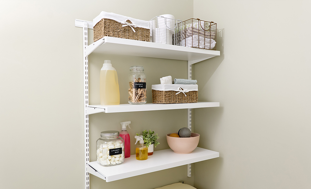 A laundry room with organized, wall-mounted shelves.