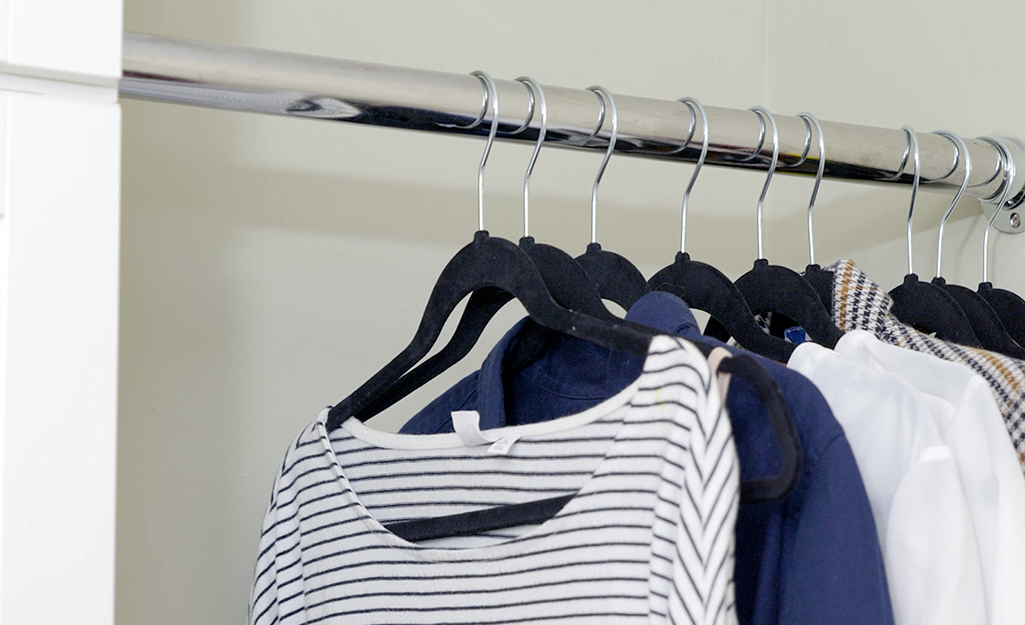 A laundry room with a hanging bar to hold clothes.