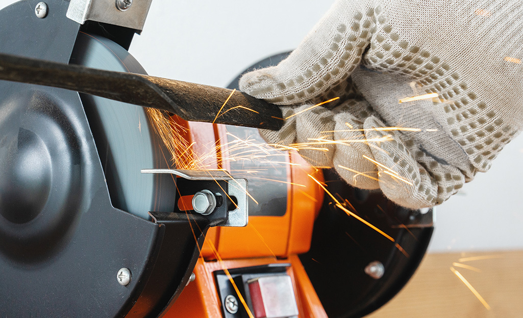 Someone sharpening a lawn mower blade.