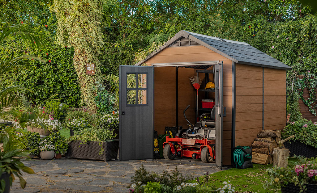 A lawn mower stored in a shed. 