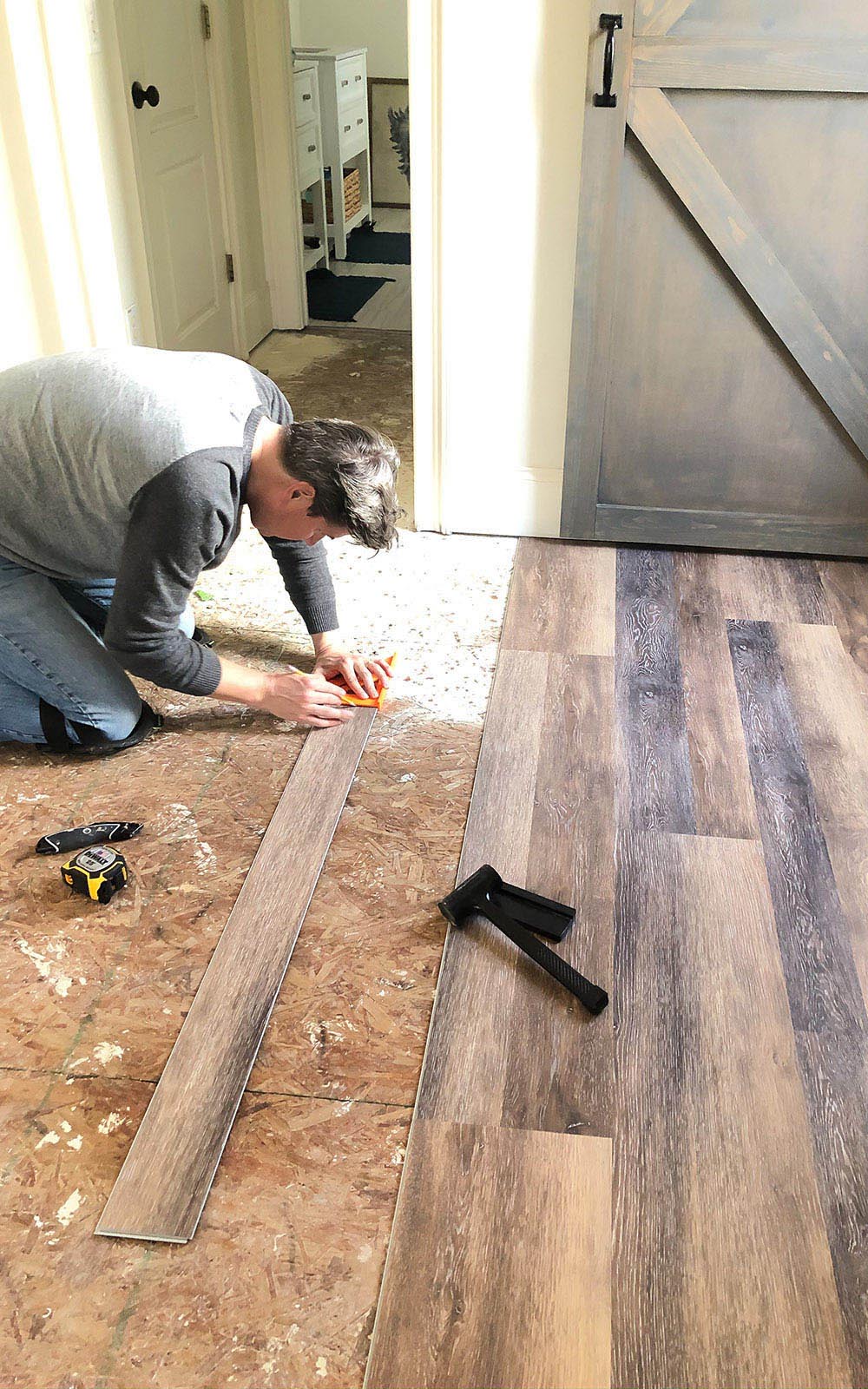A person installing LifeProof flooring 