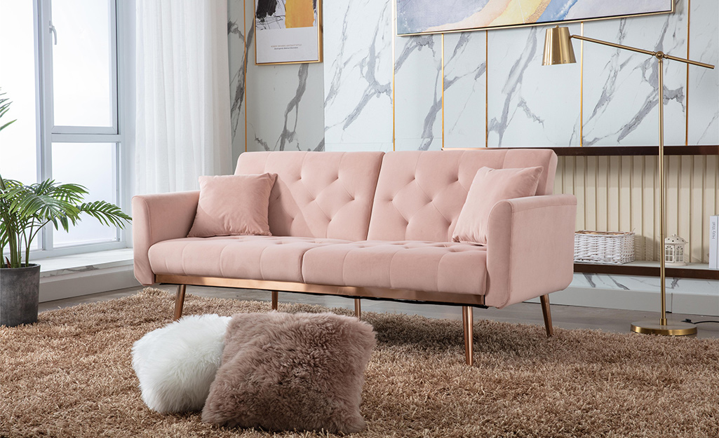 A modern living room with a pink sofa.