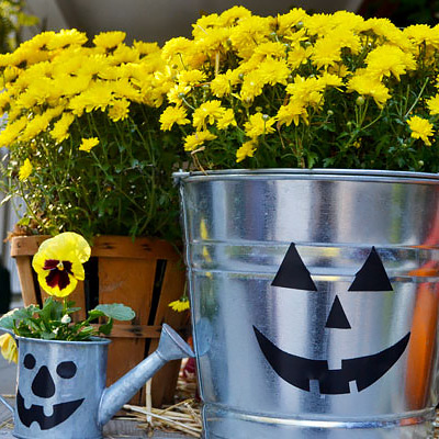 Galvanized buckets decorated for Halloween.