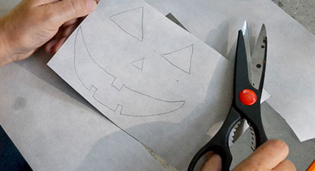 A person using scissors to cut shapes.