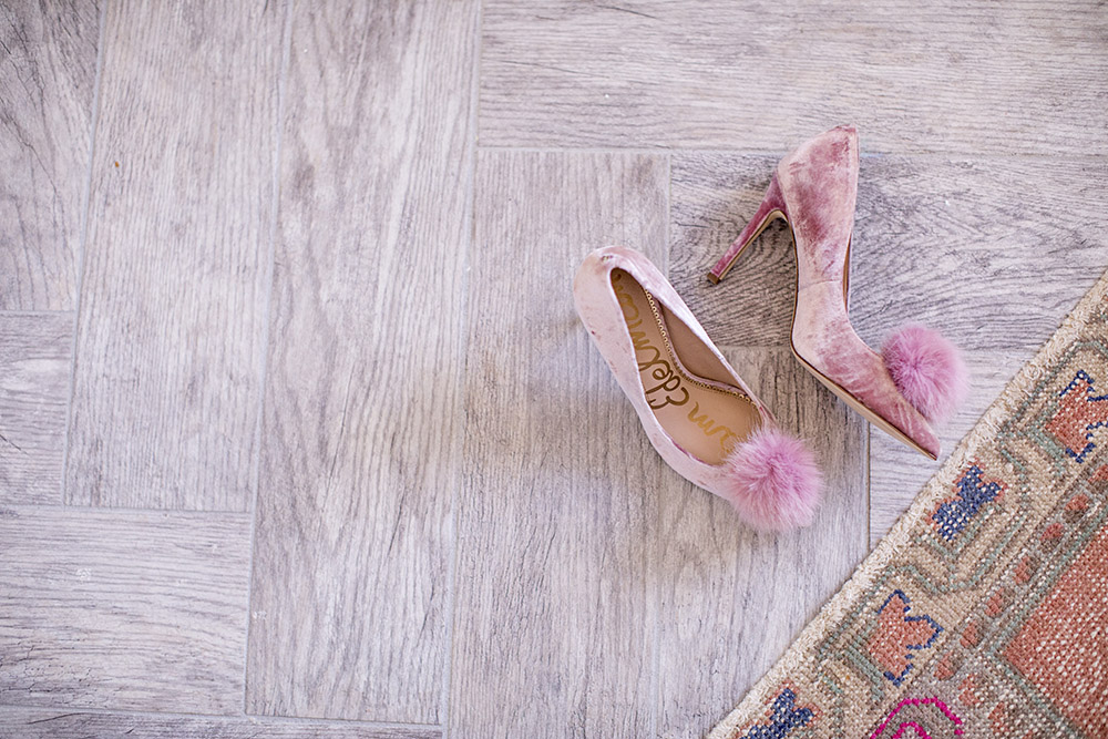 A pair of pink shoes on a gray tile floor.