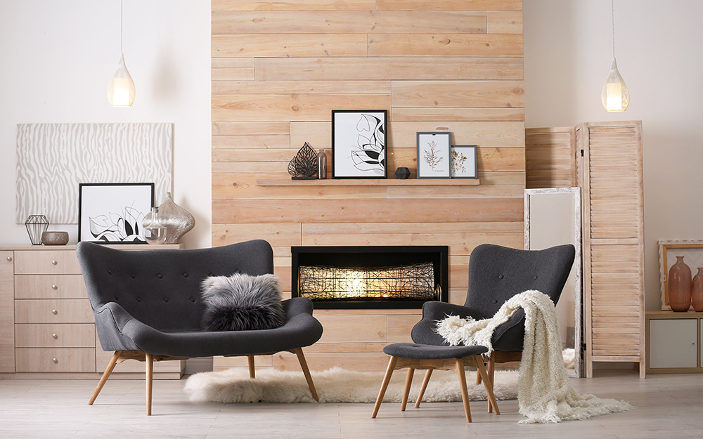 Two white-finished metal and frosted glass pendants illuminate a living room.