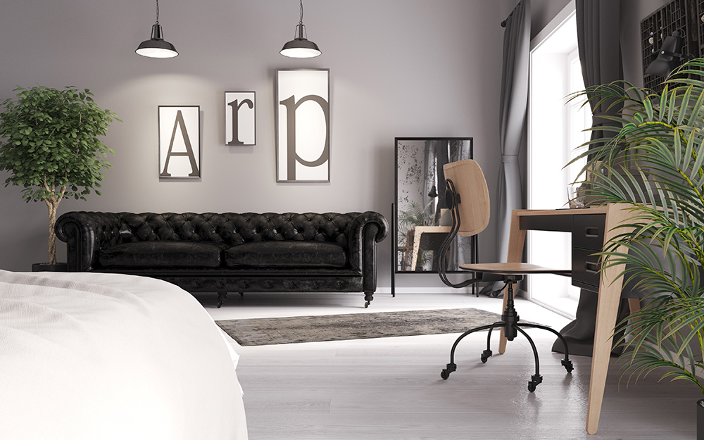  A black leather sofa, wooden desk and rolling office chair occupy space in a minimalist living room.