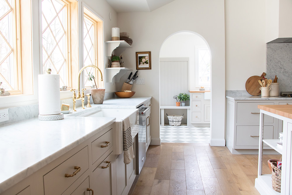 A kitchen with an arched doorway and gold accents.