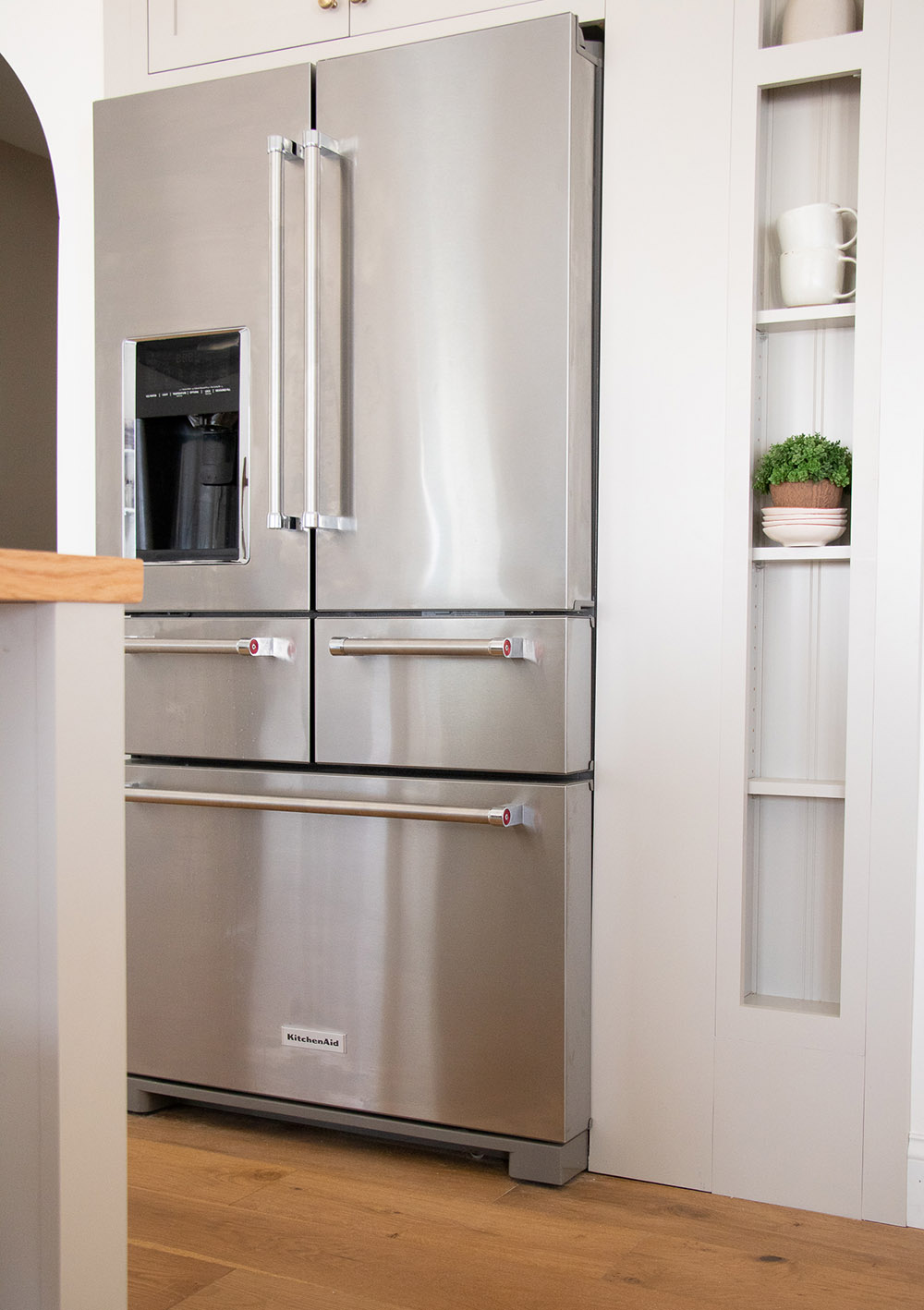 A stainless steel KitchenAid refrigerator in a kitchen.