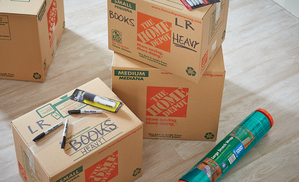 Packed Home Depot moving boxes placed in a stack.