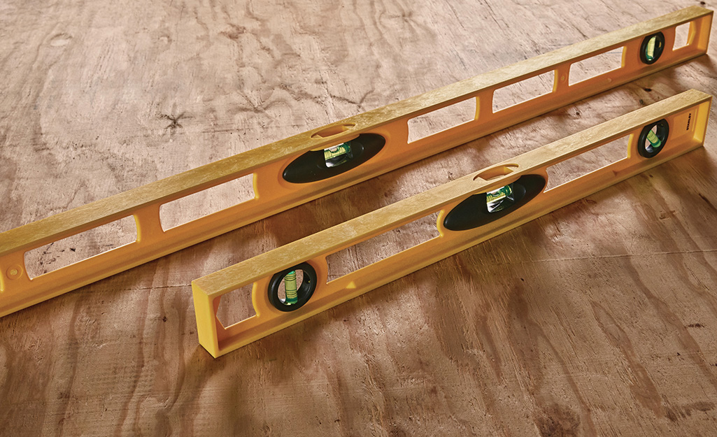 Two levels displayed side by side on a piece of wood. Two levels displayed side by side on a piece of wood.