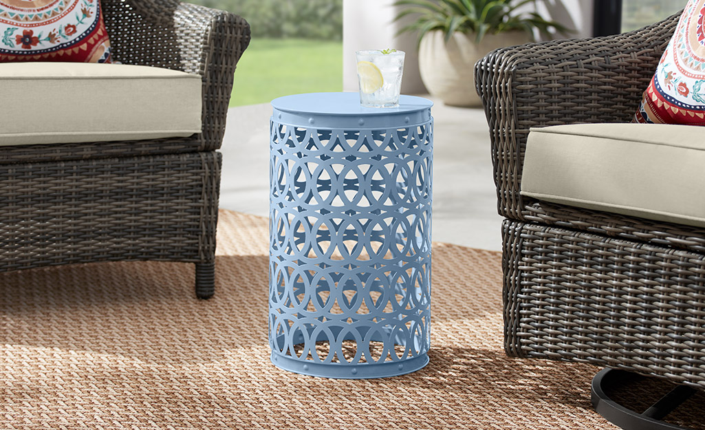 A blue garden stool in an outdoor space.