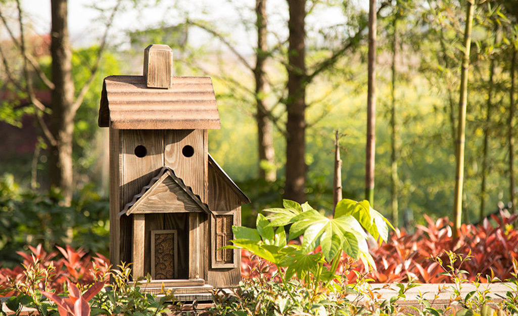A birdhouse in a garden 