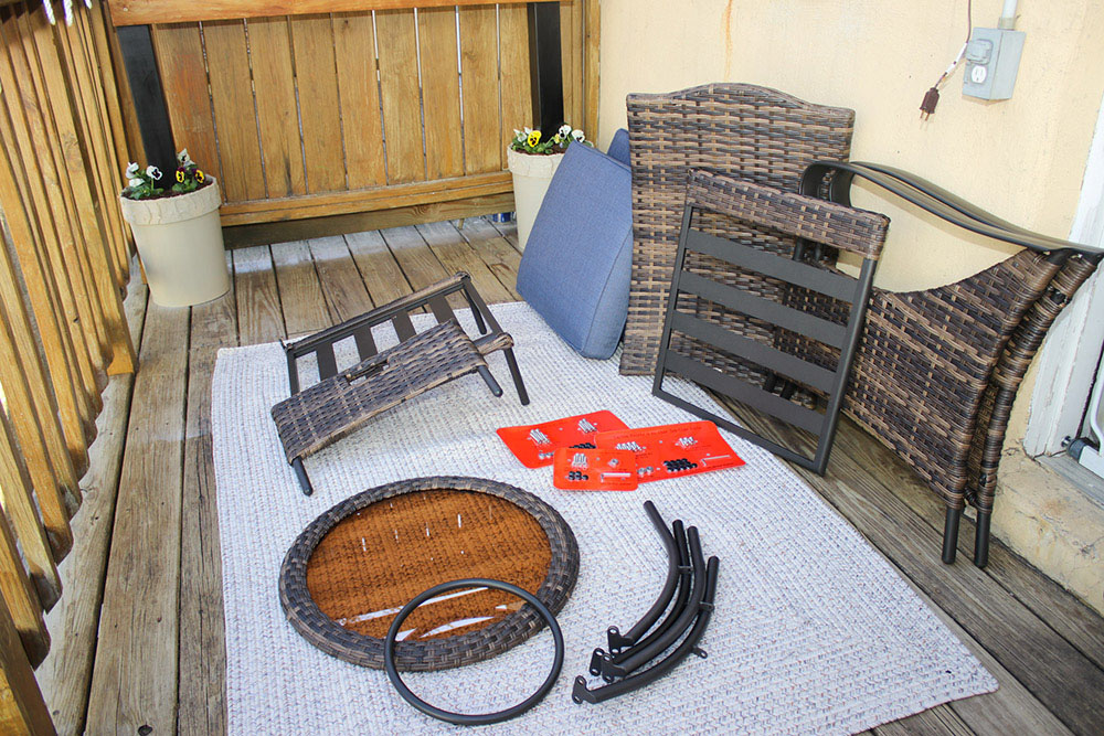 Various parts of a patio dining set ready to be assembled.