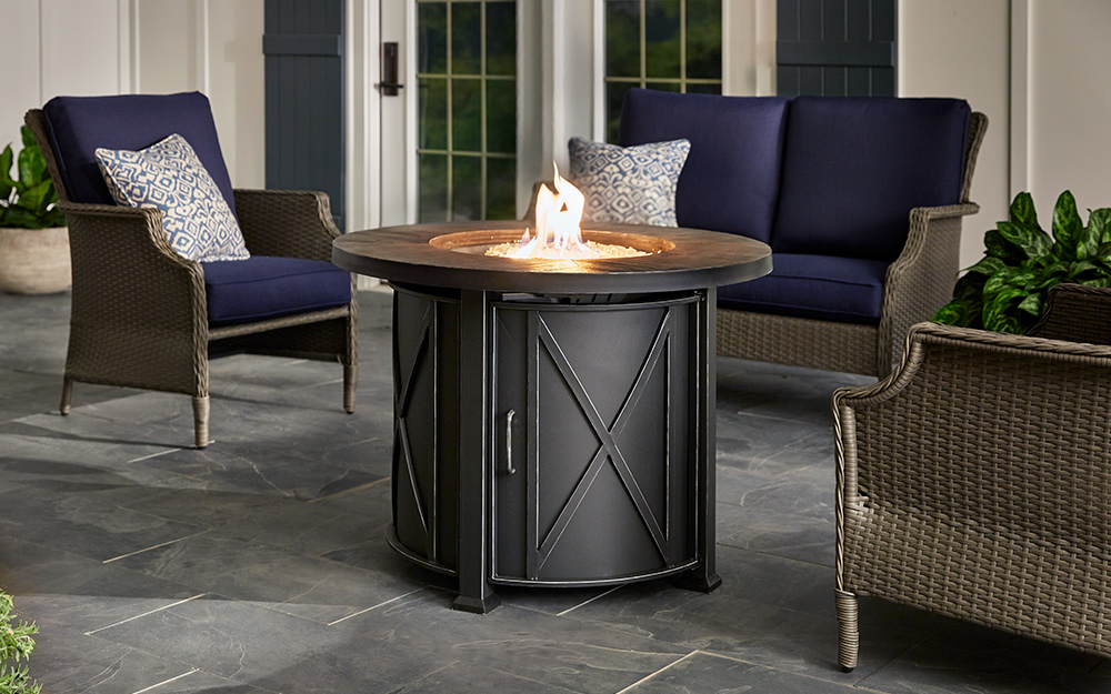 High-back patio furniture next to a gas fire pit. High-back patio furniture next to a gas fire pit.