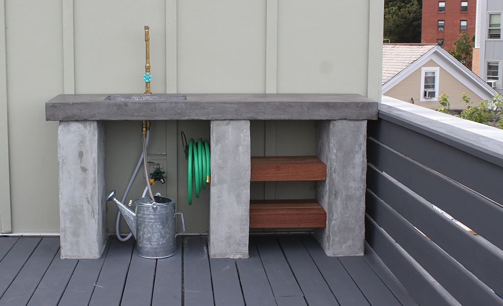 An outdoor kitchen with concrete countertops.