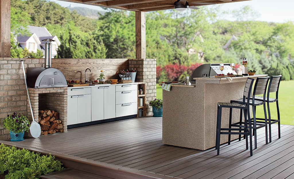 An outdoor kitchen on a covered patio.