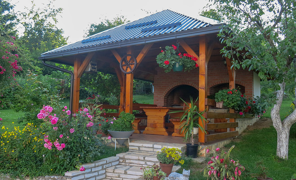 An outdoor kitchen under a pavilion. 
