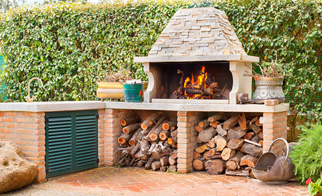 An L-shaped outdoor kitchen with a built-in grill.