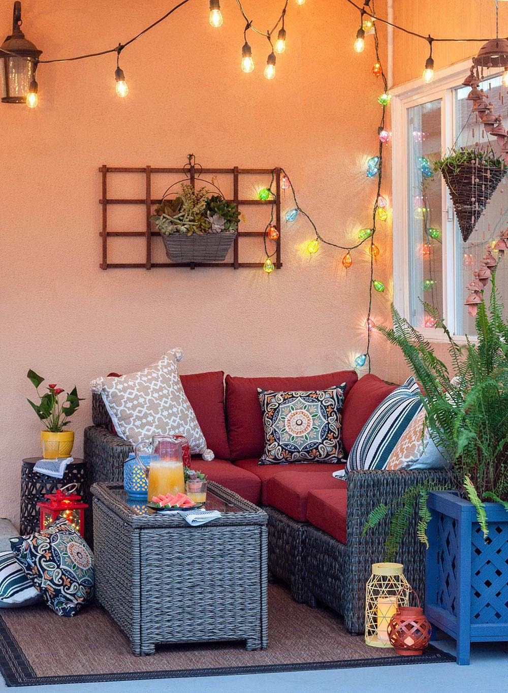 An outdoor patio decorated in bright colors with colorful string lights.