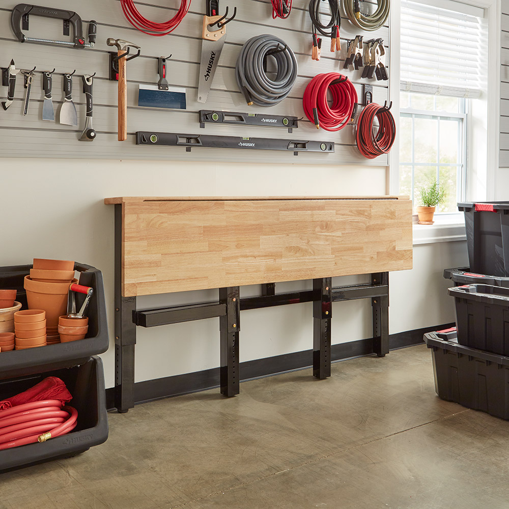 A garage workspace that has a concrete floor stained the color of sandstone.
