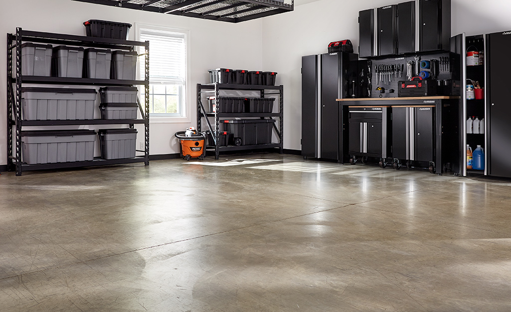A garage workspace that features a concrete floor colored with concrete stain.