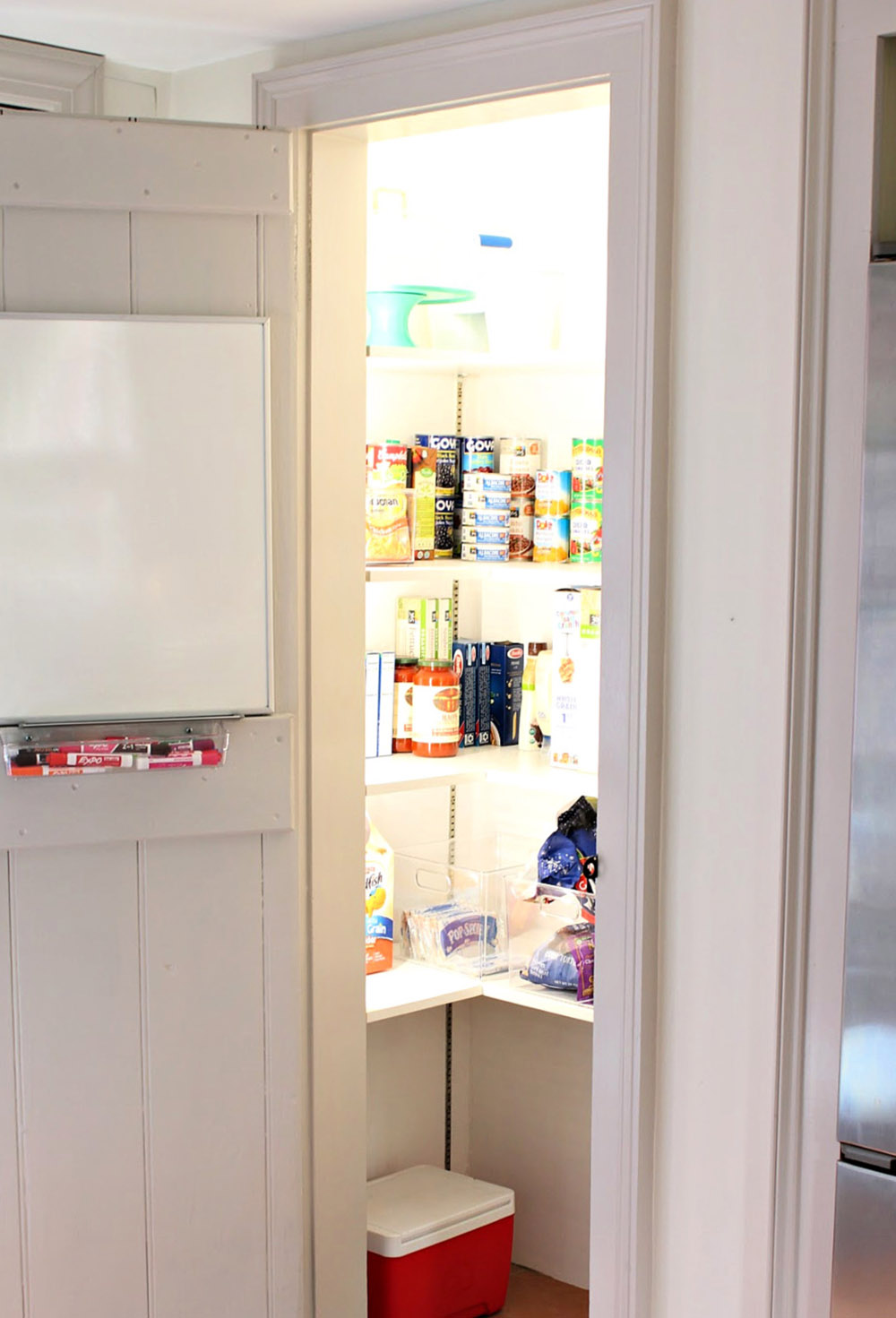 The inside of an organized and brightly lit pantry.