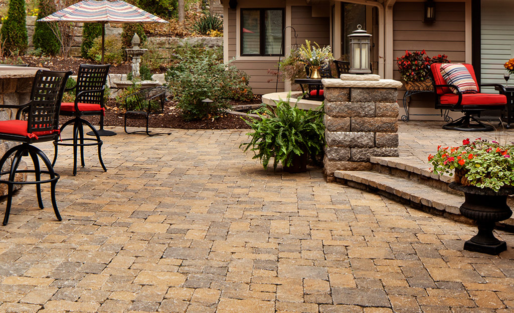 A brick two-level patio with tables and chairs.