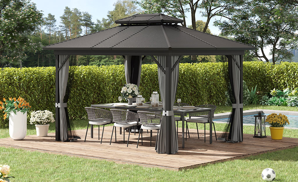 A poolside canopy with outdoor dining set. 
