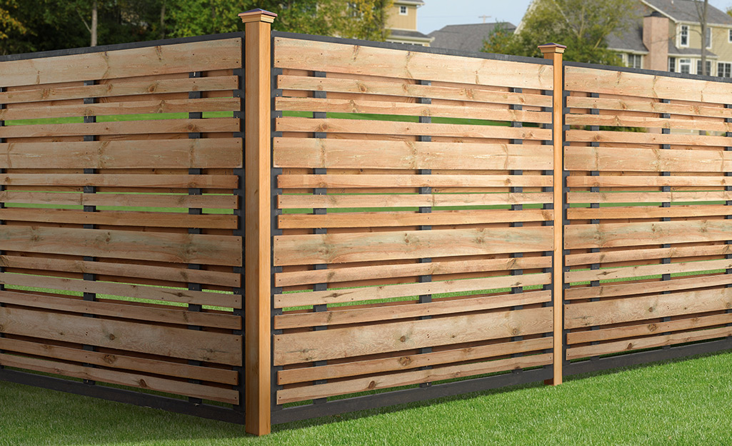 A natural wood-toned horizontal slat fence. 