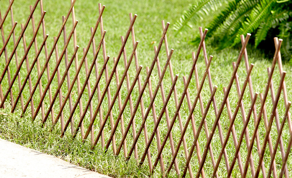 An expandable privacy fence stretches along a lawn