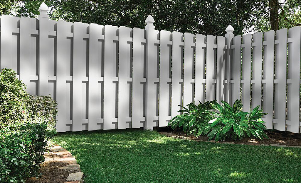 A shadow box privacy fence blocks the view of a yard