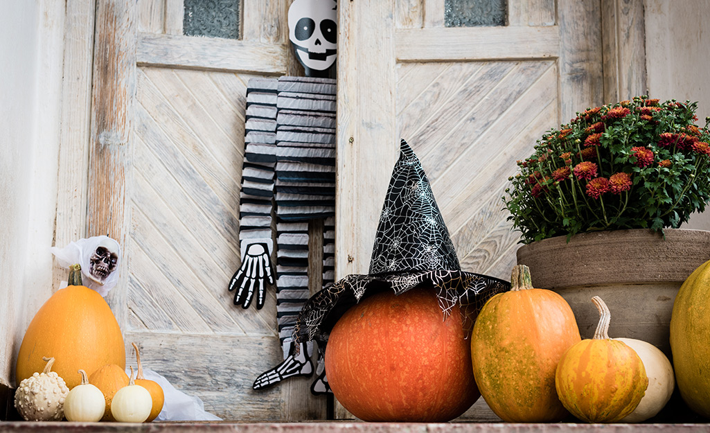 A porch decorated with pumpkins.