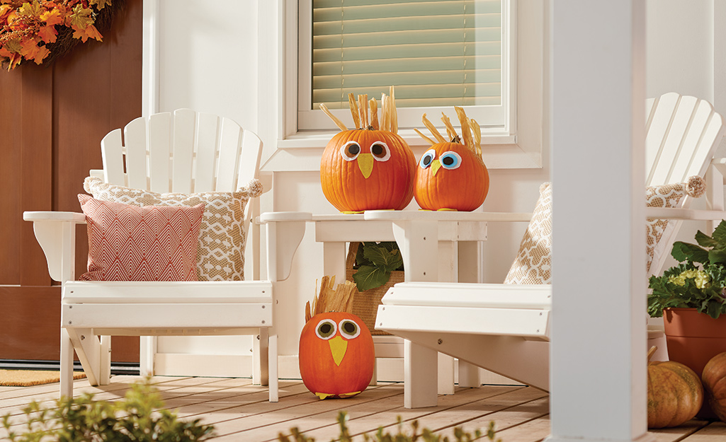 Pumpkins decorated with silly faces made from paper.