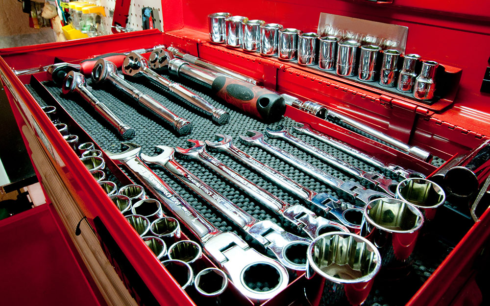 A ratchet and socket set in a toolbox.