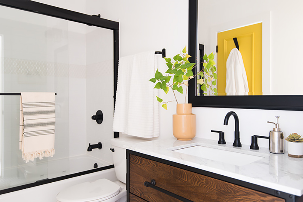 A renovated 36-yar-old bathroom with a new vanity, shower, and decor.