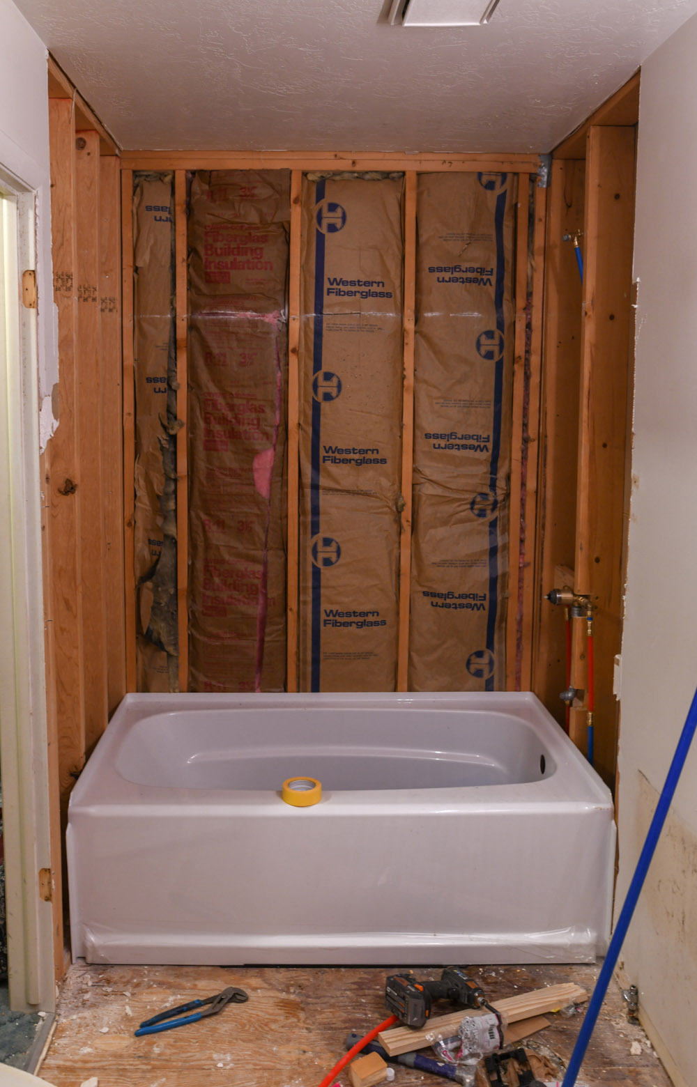 A bathroom shower down to the studs with a bathtub. A bathroom shower down to the studs with a bathtub.