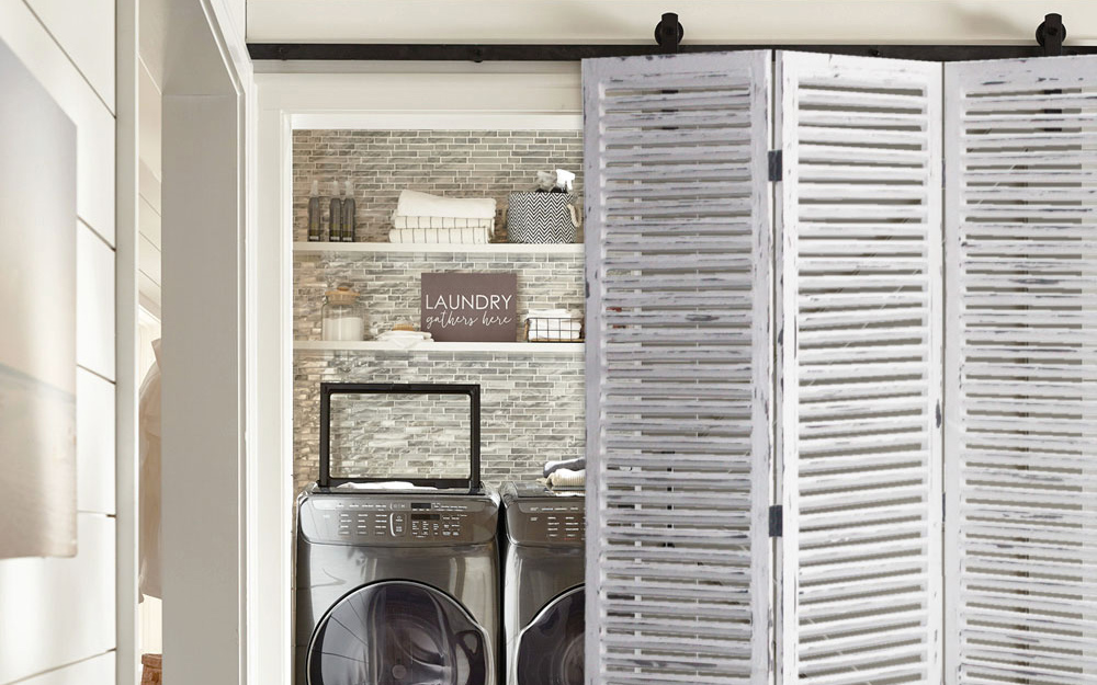 A painted white wall divider separating a laundry room.