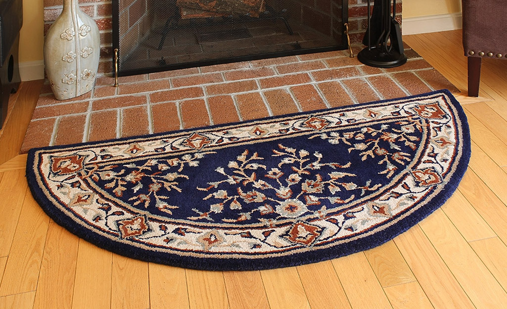 A hearth rug placed in front of a fireplace.