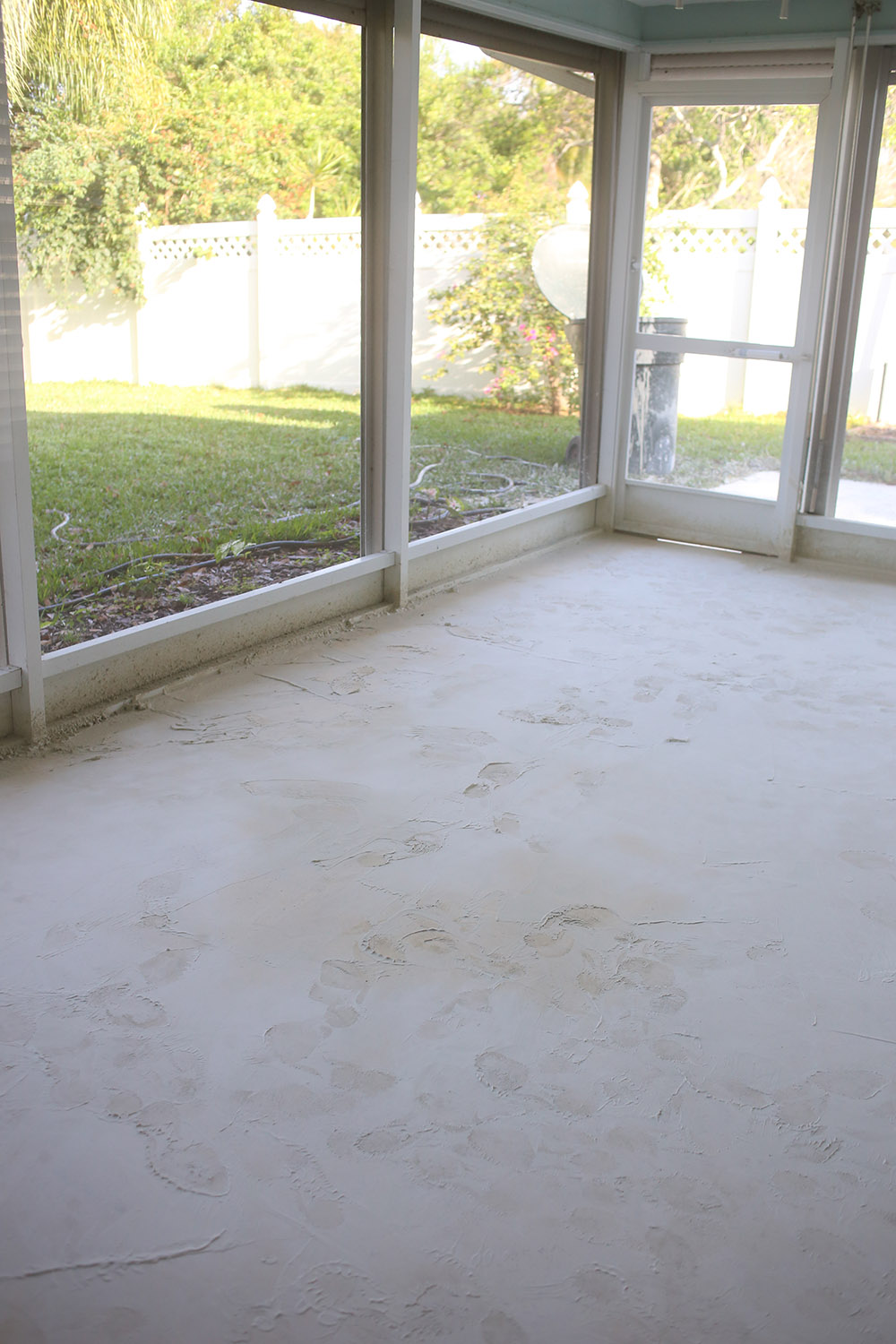 A concrete patio surrounded by windows. A concrete patio surrounded by windows.