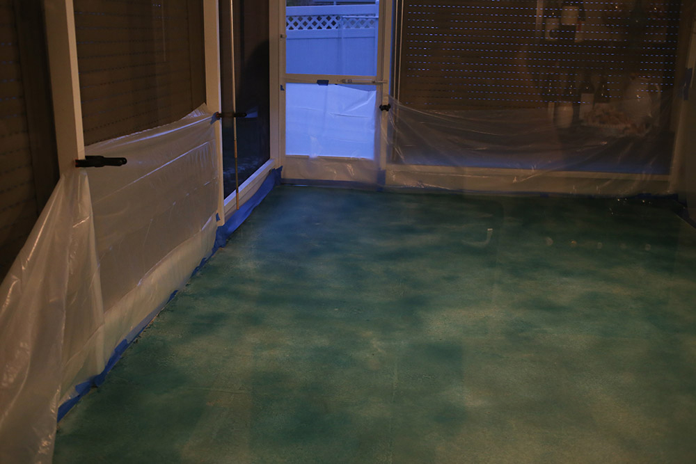 A concrete patio that has been dyed in the color Emerald Pool by Behr. A concrete patio that has been dyed in the color Emerald Pool by Behr.